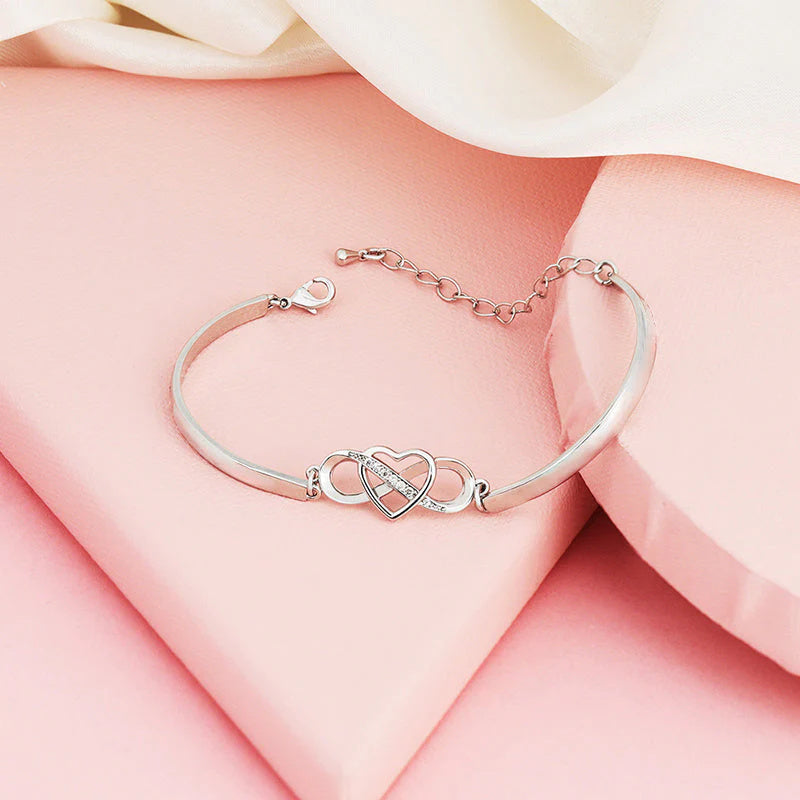 Silver women's bracelet featuring an engraved heart, a thoughtful mom gift.