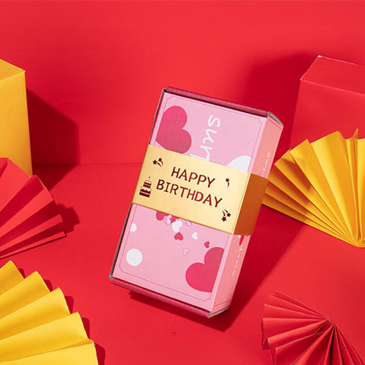A hand reaching out to open the Exploding Surprise Gift Box, anticipation for the bouncing cubes.