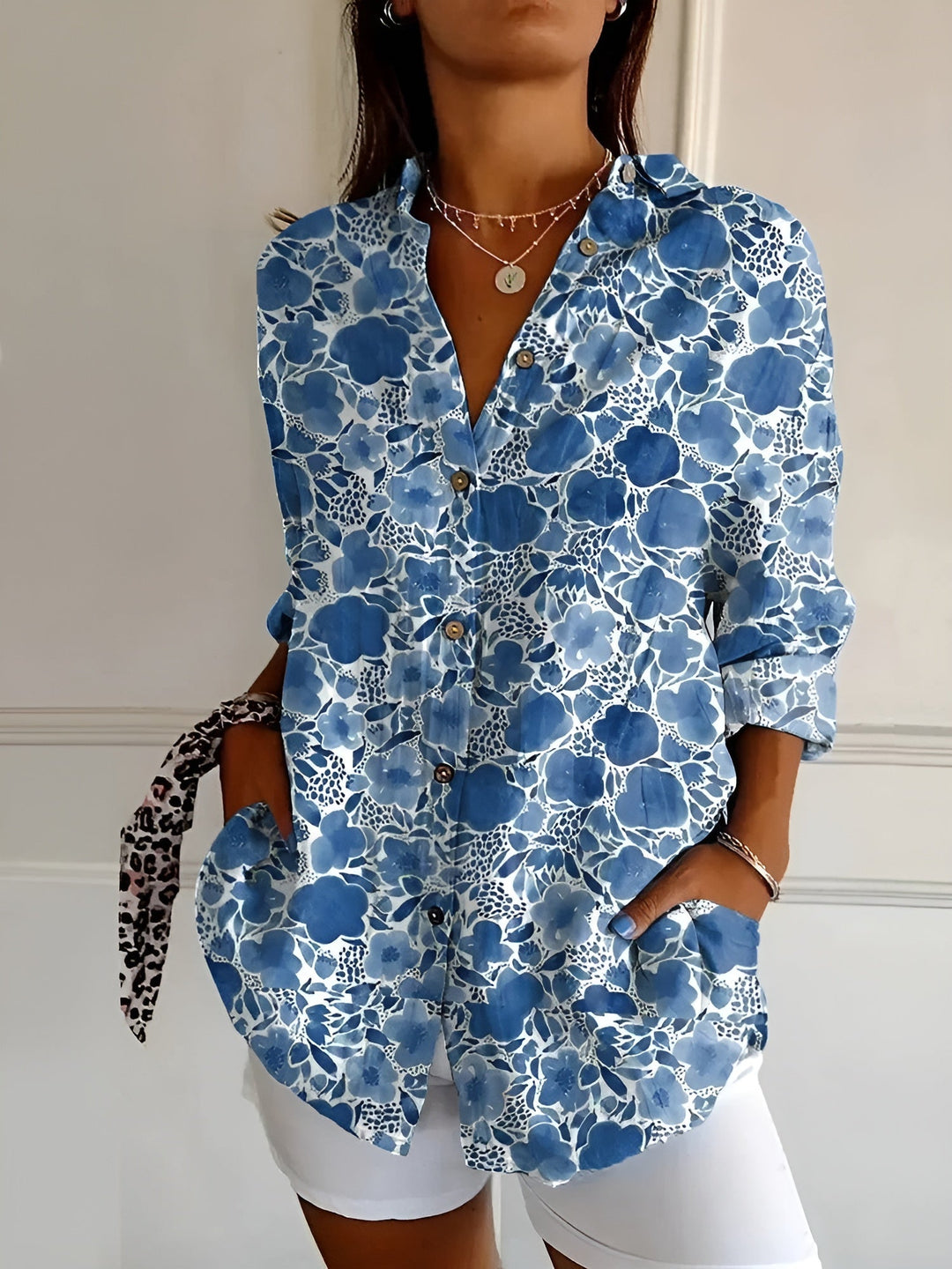 Fashionable women's printed blouse with button-front, three-quarter sleeves & collar, perfect for spring/summer.