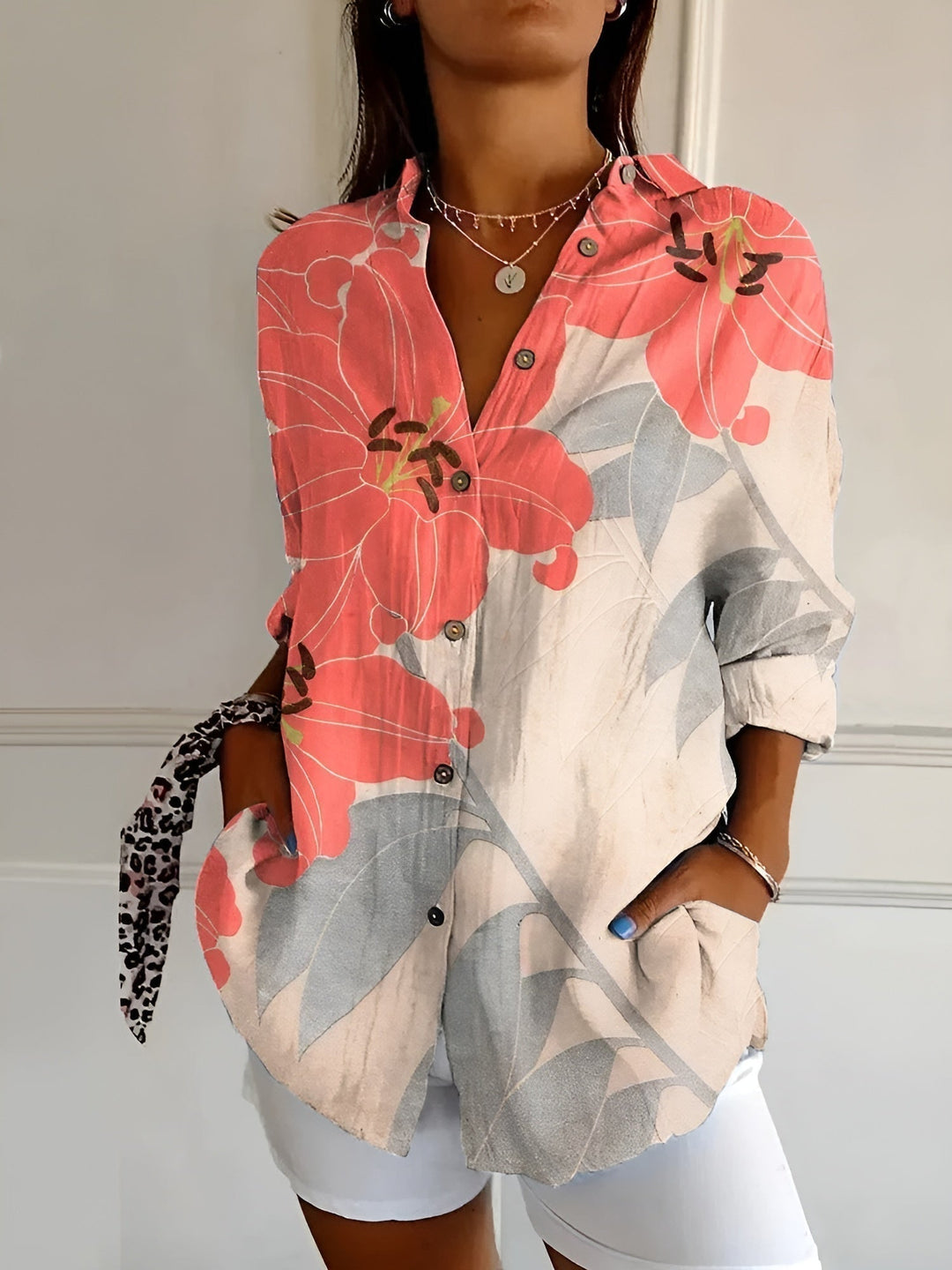 Modern women's printed collared shirt featuring a button-front closure and three-quarter sleeves for a chic style.