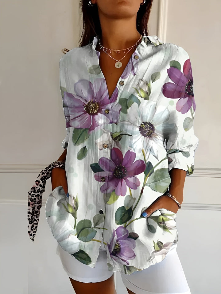 Women's printed button-front blouse with three-quarter sleeves. A fashionable and versatile collared top.