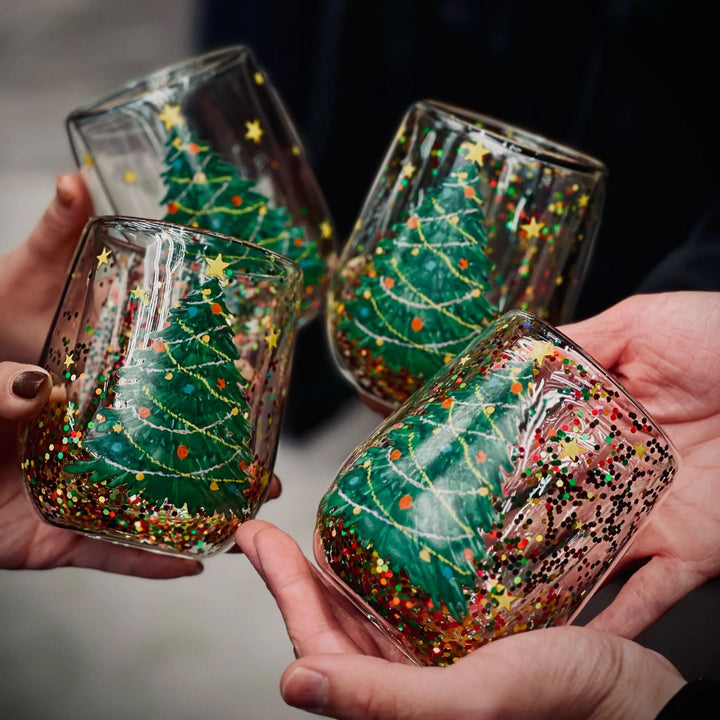 Festive Christmas Tree Glass Tumbler with glitter & holiday decor. Perfect drinkware gift.