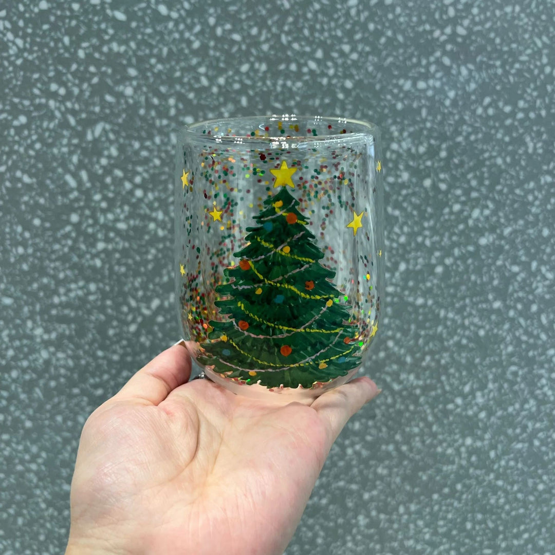 Christmas Tree Glass Tumbler, festive, with glitter, for holiday drinks. Ideal kitchen decor gift.