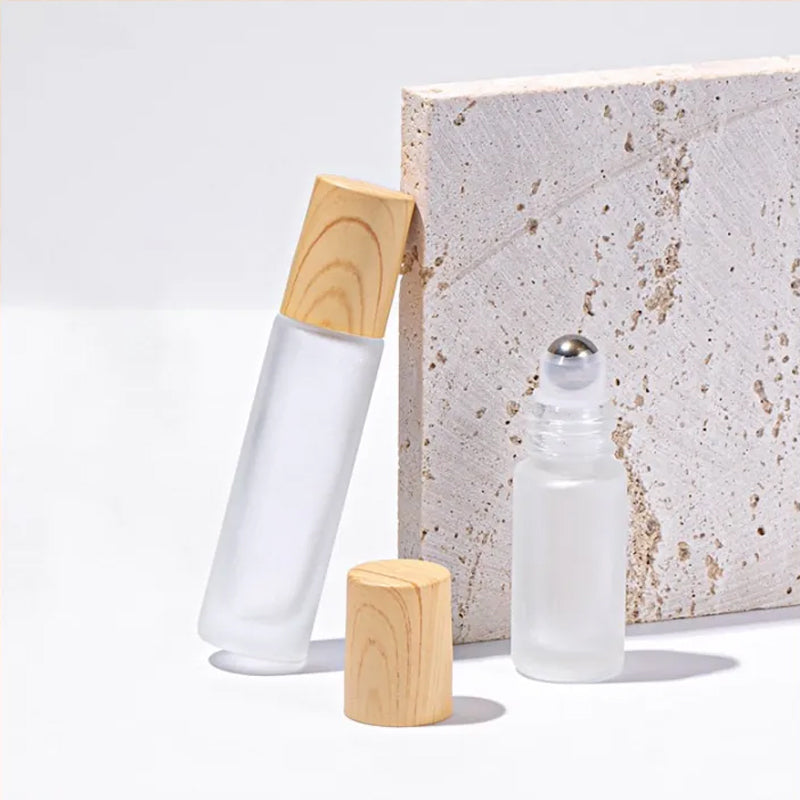 Five essential oil roller bottles, empty and clean, ready for personal customization with aromatherapy blends