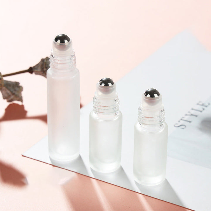 Detail of the stainless steel roller ball on a refillable essential oil bottle, ensuring smooth application