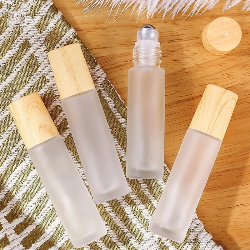 Group of five clear glass roller bottles, perfect for travel-size essential oil storage and application, eco-friendly