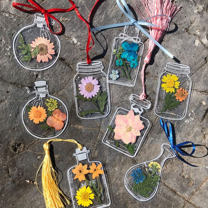 Assortment of handmade transparent bookmarks, each with a distinct floral pattern