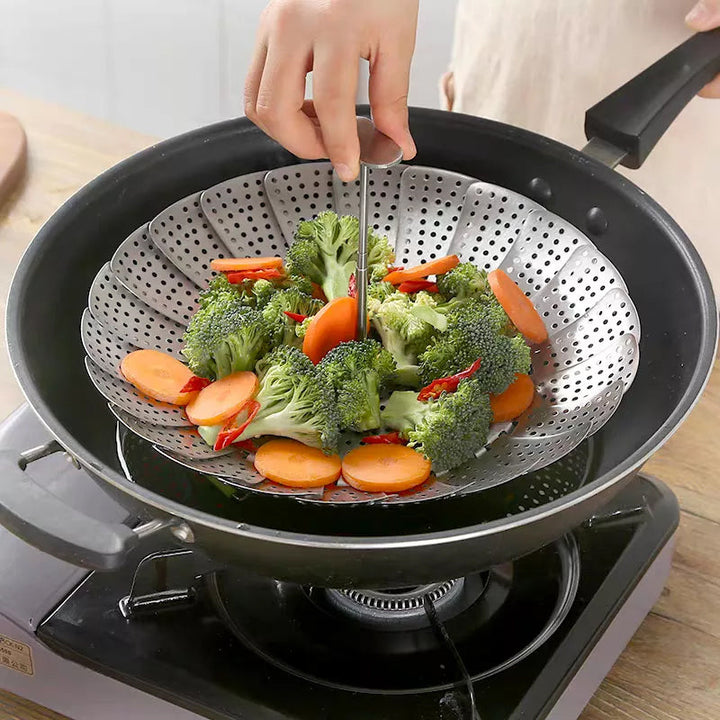 Close-up of the intricate flower design on a folding stainless steel steamer basket, cooking essential