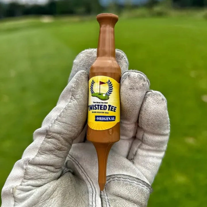 A single recyclable beer bottle golf tee standing upright on a golf course, ready for a swing.