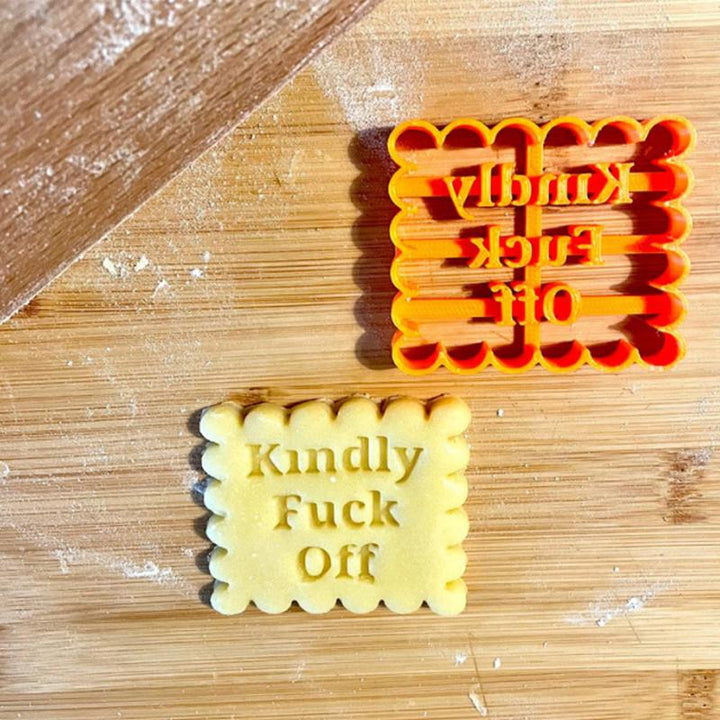 Kitchenware set of orange, plastic cookie molds, each with a different fun phrase for baking.