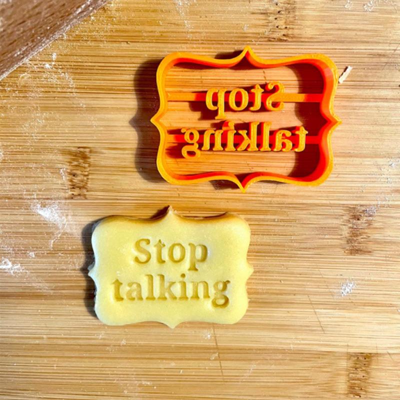 Orange cookie cutters with humorous phrases, a 4-piece set for fun and easy DIY baking.