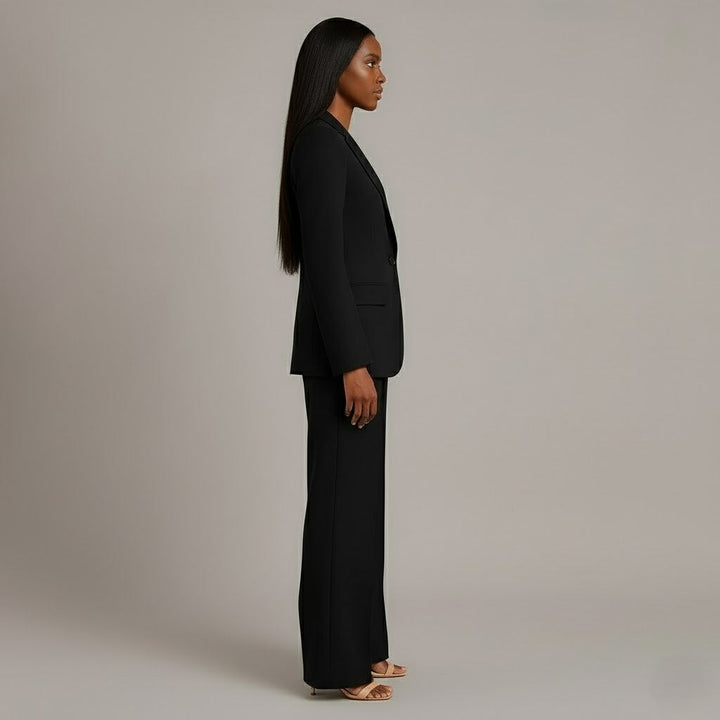 Close-up of the premium fabric on a women's tailored formal suit, highlighting quality and texture.