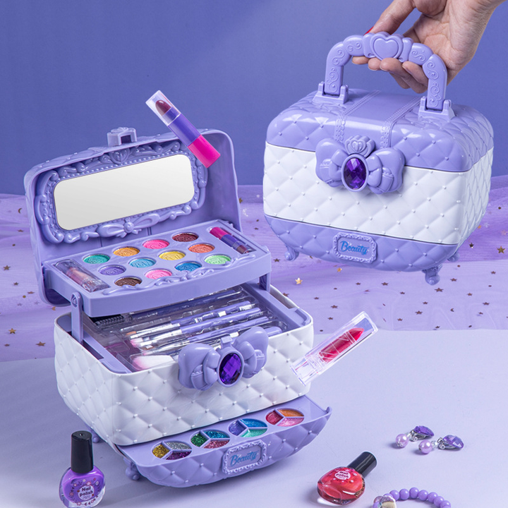 Toddler girl smiling while playing with a washable beauty kit, an educational toy