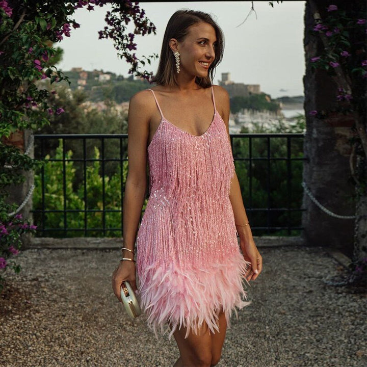 Women's glamorous sleeveless pull-over mini dress featuring playful feather details. Ideal for parties.