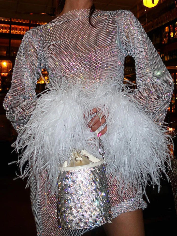 Sparkling bodycon sequin mini dress featuring chic feather cuffs & long sleeves for evening wear.