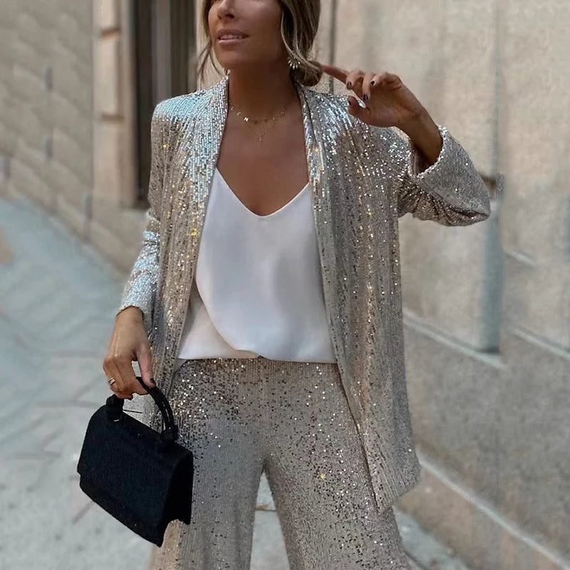 Elegant women's sequin two-piece outfit with a shimmering top and comfortable high-waisted pants.