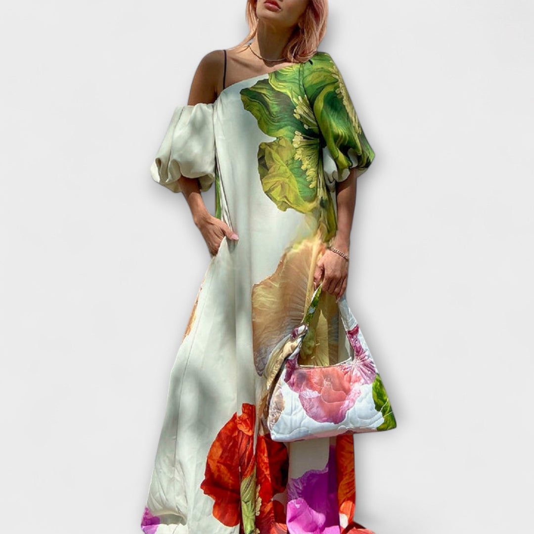 Green floral maxi dress for women with elegant asymmetrical neckline & puff sleeves, perfect for summer events.
