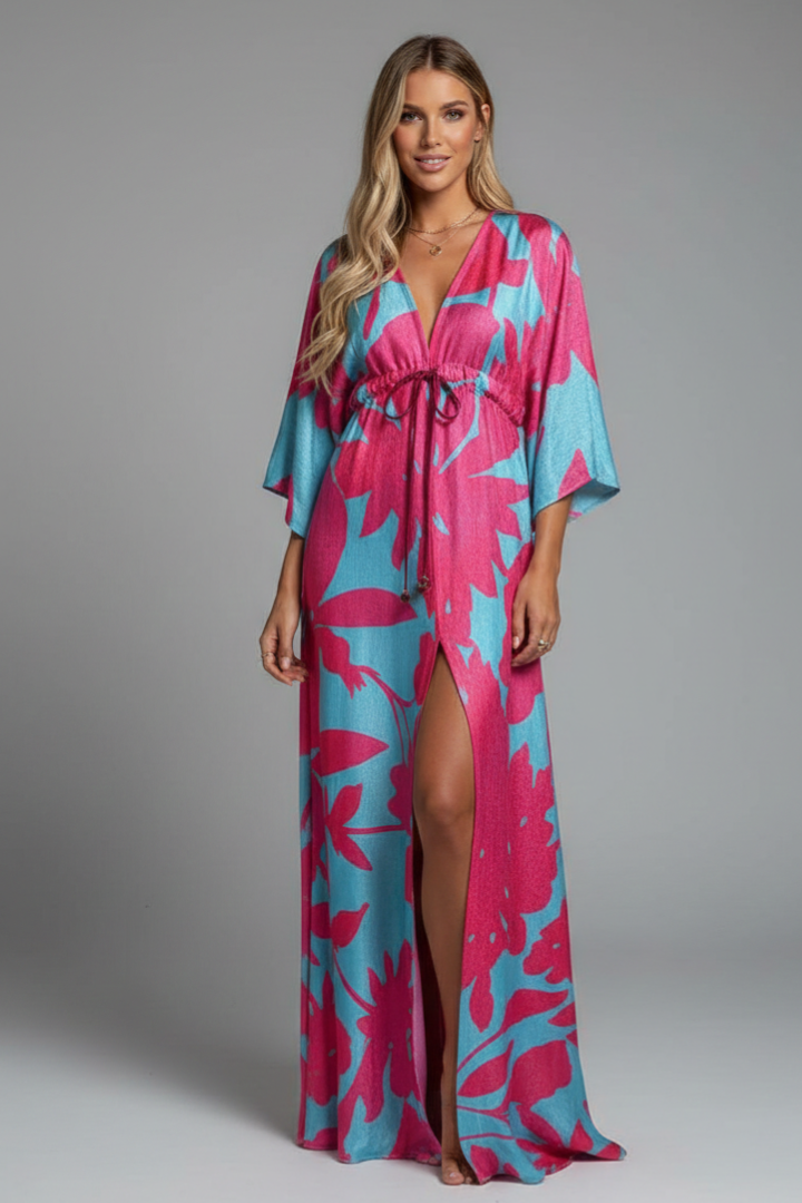 Green printed women's flowy V-neck maxi dress with adjustable tie waist and elegant batwing sleeves.