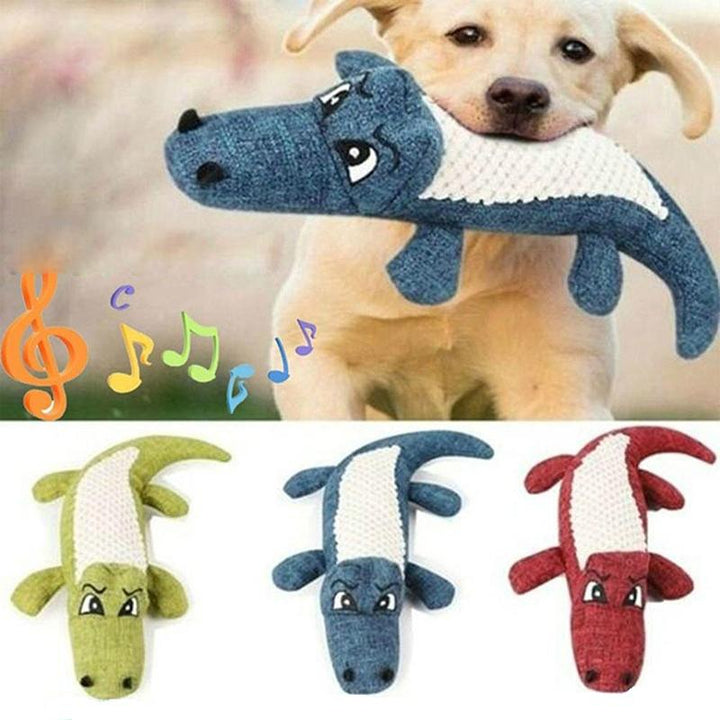 Close-up of a dog holding a Pet Crocodile Squeaking Chew Toy, engaging pet supplies for entertainment