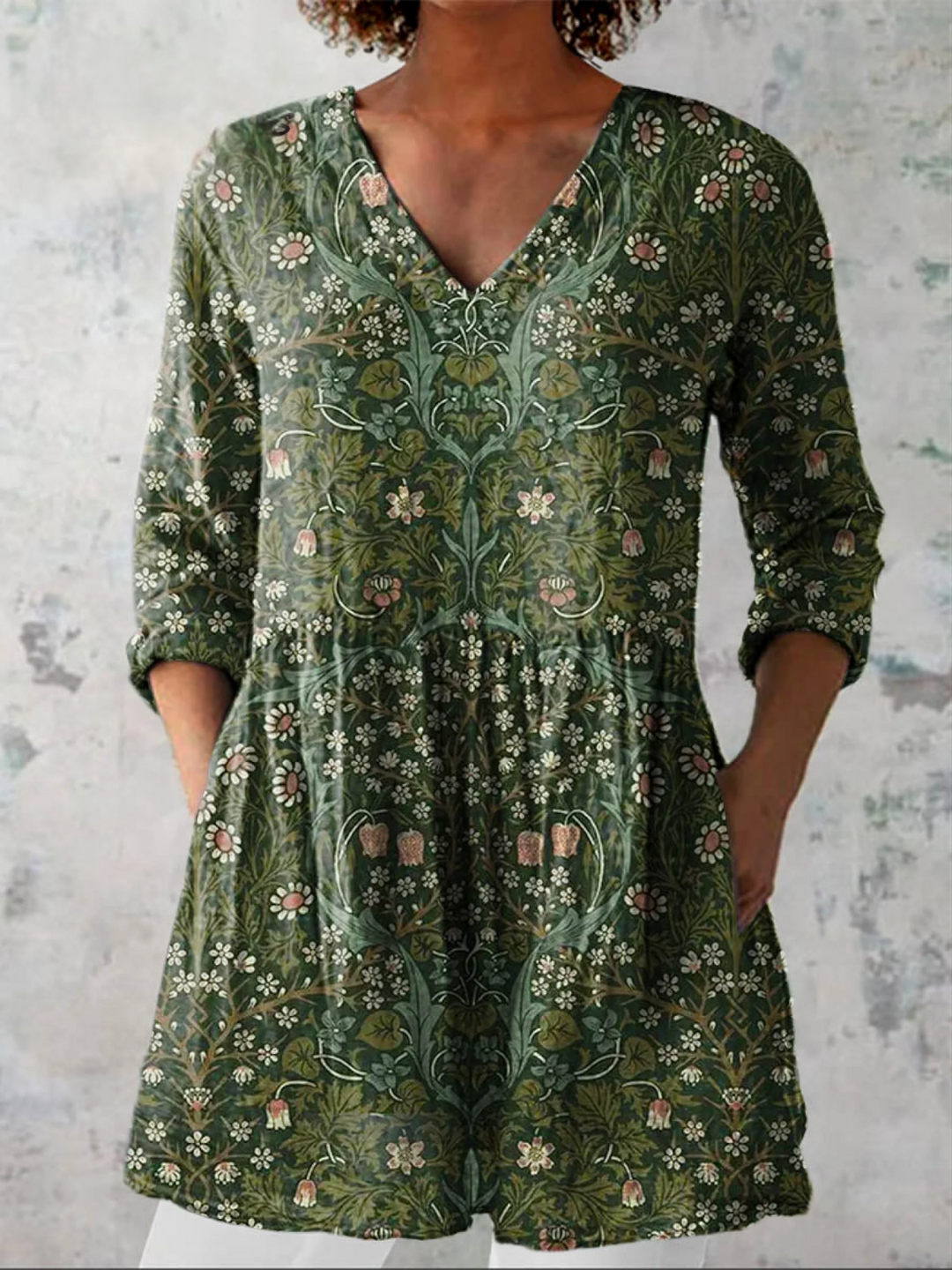 Green women's V-neck loose tunic top with three-quarter sleeves & pockets. Comfortable casual blouse for daily wear.