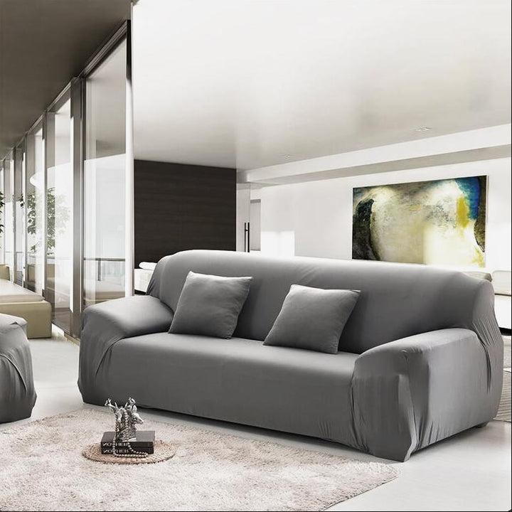 Installation view of a white stretch slipcover on a sofa, demonstrating easy application for home decor.