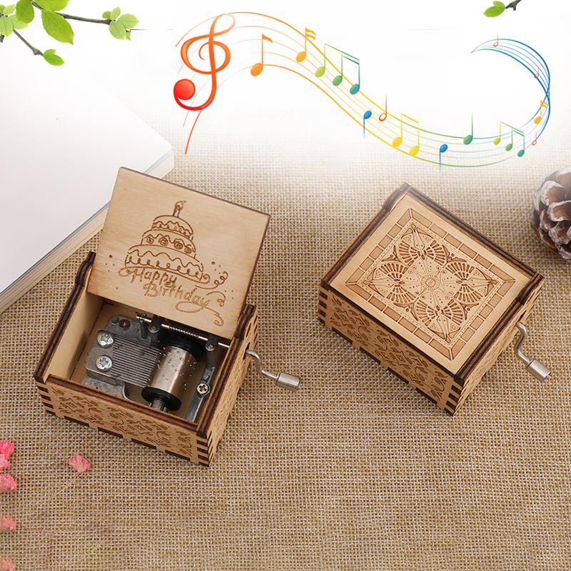 Close-up of a handcrafted wooden music box, showcasing fine grain and a delicate crank mechanism