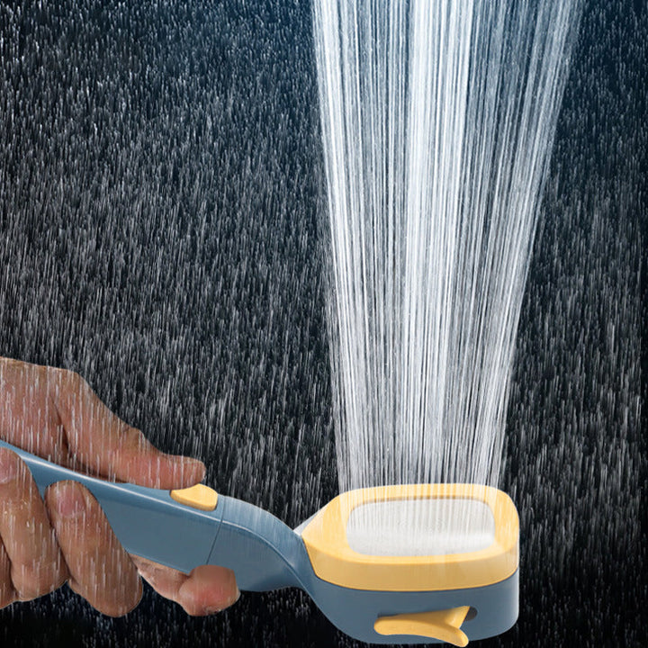 Angled shot of a modern handheld shower head, highlighting its pressurized spray and on/off pause switch.