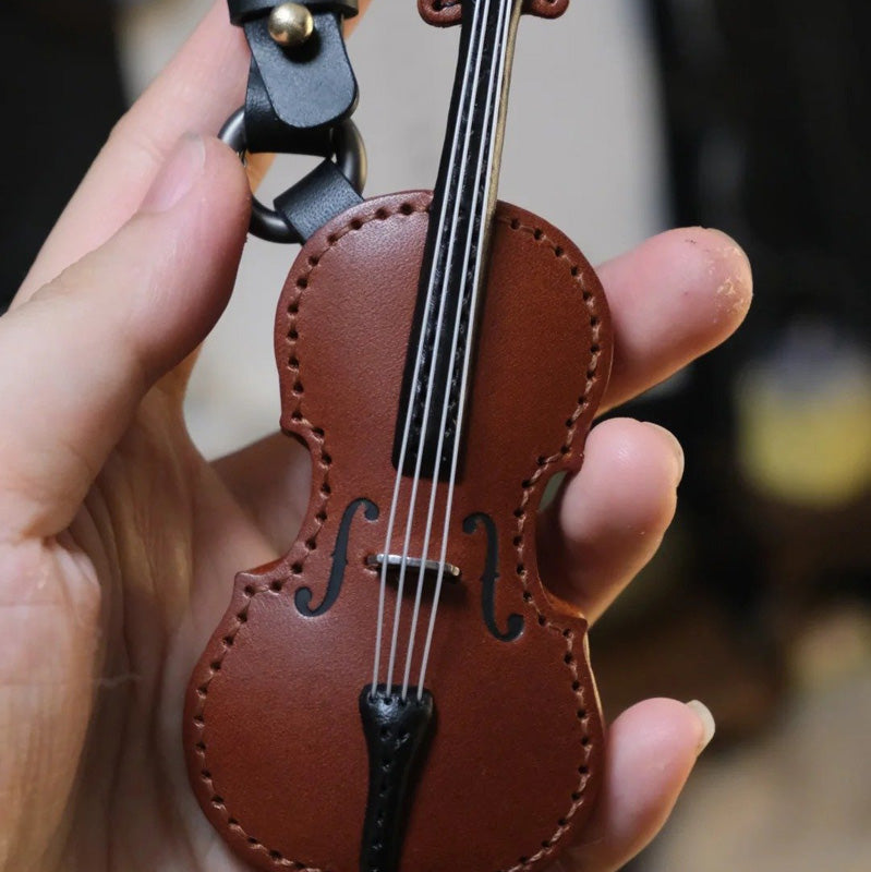Finely crafted leather cello keychain, showcasing texture and musical design