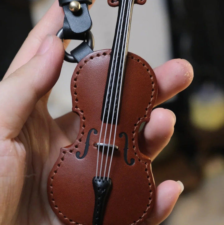 Finely crafted leather cello keychain, showcasing texture and musical design