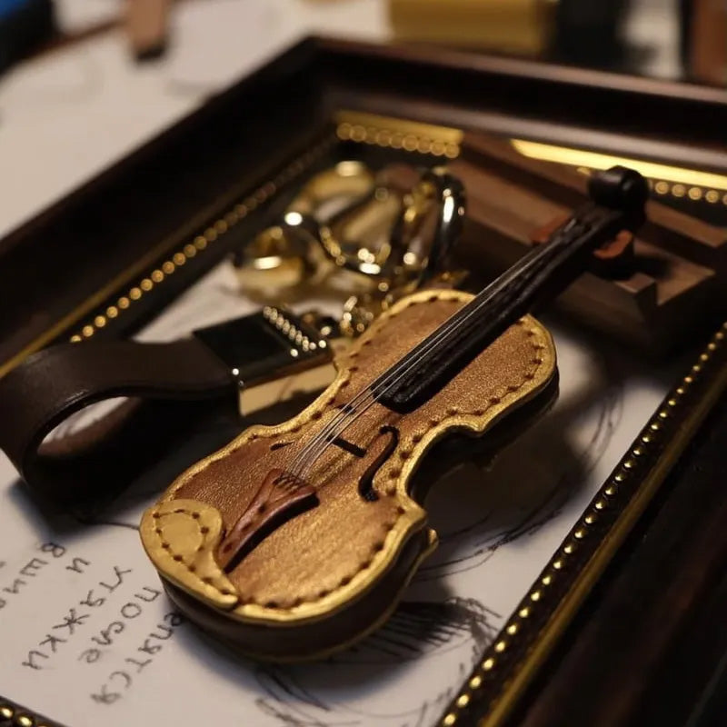 Detailed leather musical instrument keychain, ideal for violin or cello enthusiasts