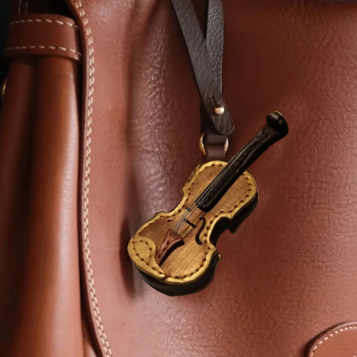 Close-up of a handmade leather violin keychain, highlighting craftsmanship & detail
