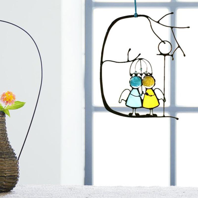 Handmade stained glass angel suncatcher, iridescent wings, holding a heart, for window hanging home decor.