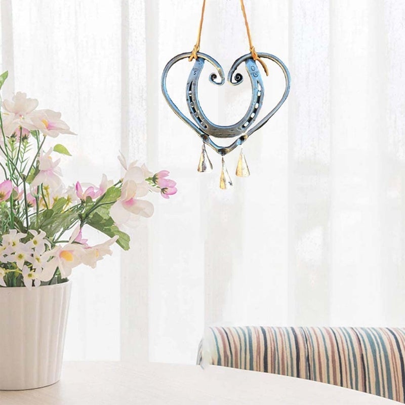Decorative heart-shaped metal wind chime, a unique piece of garden art and thoughtful gift.