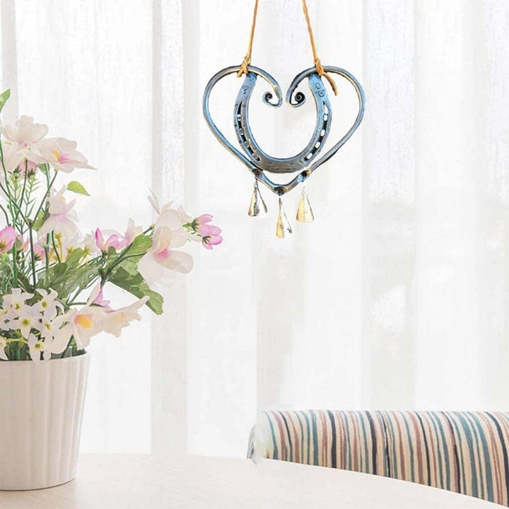 Decorative heart-shaped metal wind chime, a unique piece of garden art and thoughtful gift.