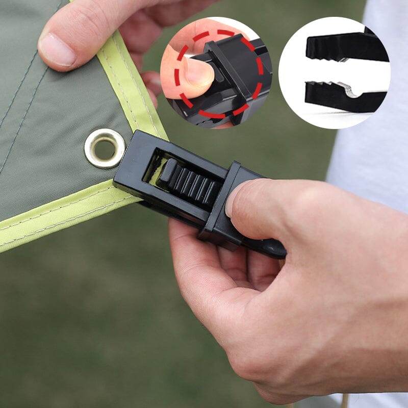 Heavy duty tarp clips in use, securing a blue tarp to a frame for sun protection.