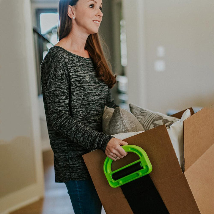 Unisex moving and lifting straps in action, aiding in transport of a large wooden cabinet
