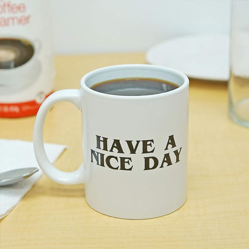 Close-up of a humorous ceramic mug, showcasing the funny text