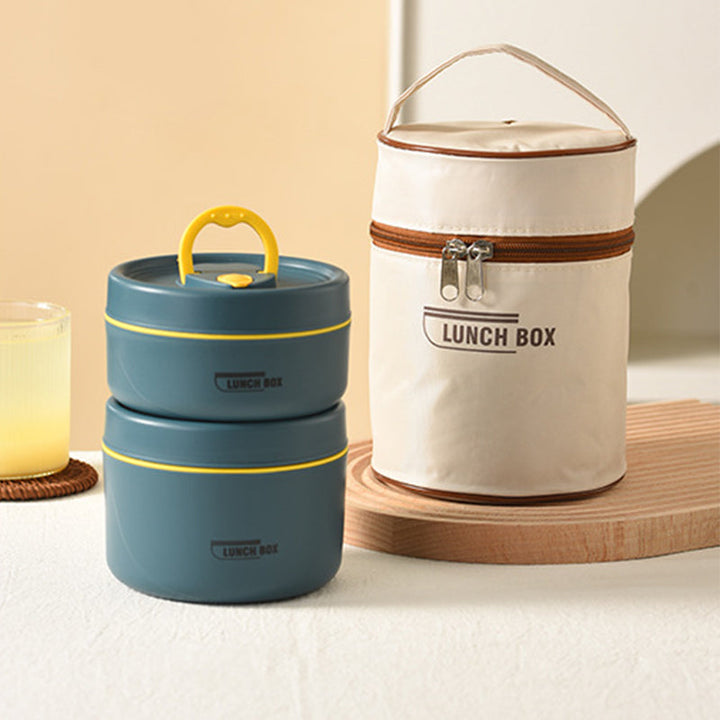 Professional carrying an insulated stainless steel lunch container set to work, for fresh, homemade meals