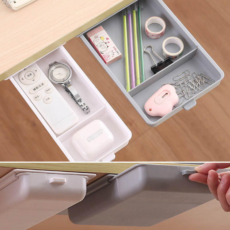 Invisible storage drawer for desk, shown with pens and sticky notes, enhancing productivity.