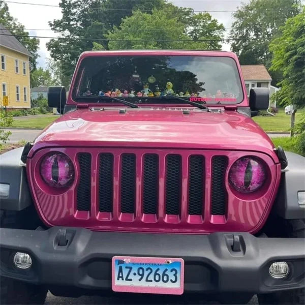 Close-up of Beast Eyes perforated headlight decal on a Jeep headlight; auto styling, unique car accessory