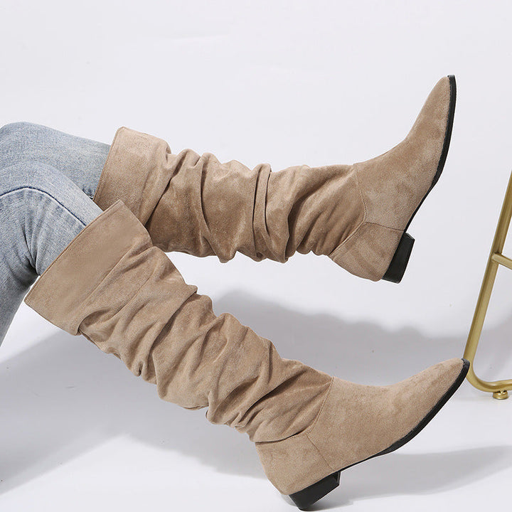 Close-up of women's slouchy knee-high boots showcasing the textured material and block heel
