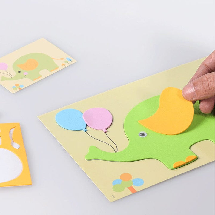 Toddler proudly displaying finished animal foam sticker art, a fun and engaging DIY activity.