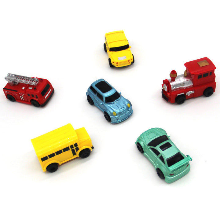 Yellow inductive toy car with a child's hand drawing its next path