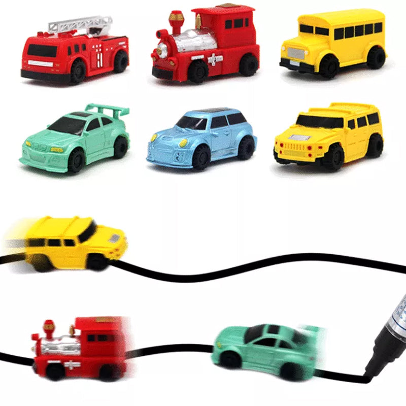 Hand holding a red inductive car toy, ready to follow a drawn path