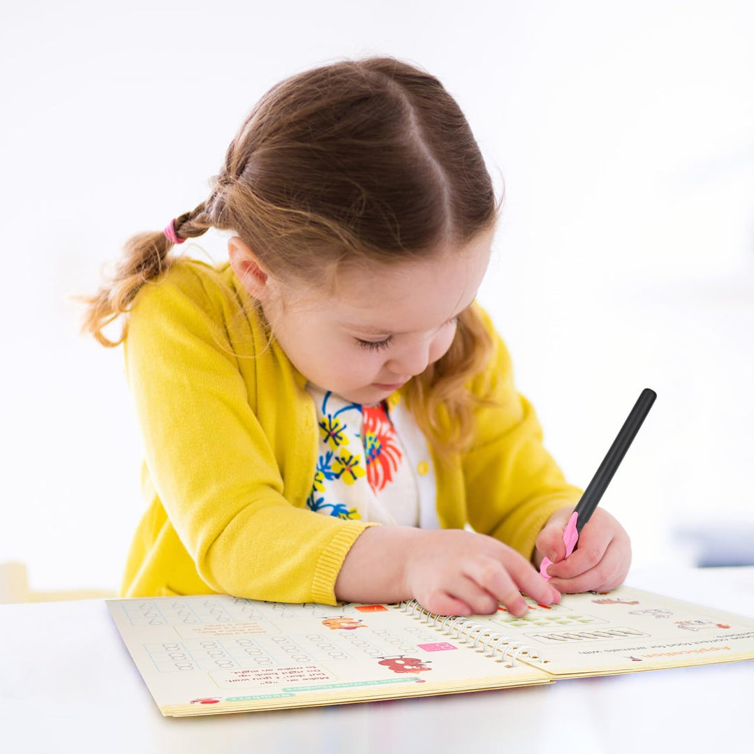 Toddler using a magic ink pen on a reusable math skills book, engaging early education tool