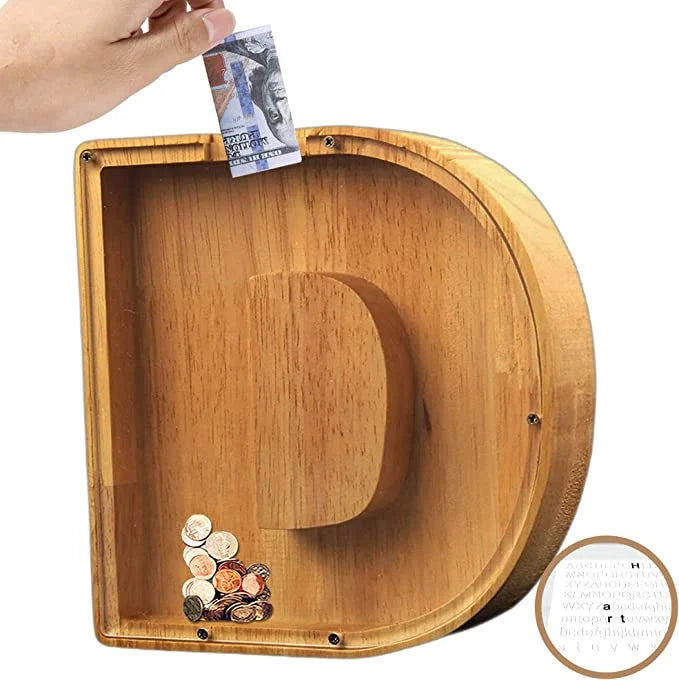 Playful image of a child's hand dropping a coin into a Personalized Wooden Alphabet Piggy Bank