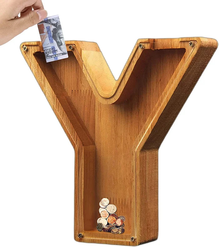 Cozy bedroom setting with a Personalized Wooden Alphabet Piggy Bank on a bedside table