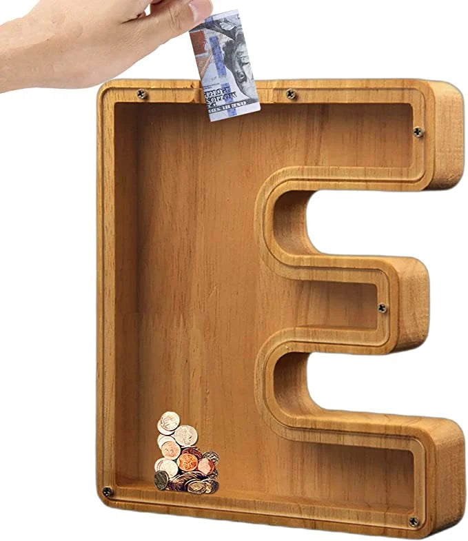 Child proudly holding their Personalized Wooden Alphabet Piggy Bank, featuring their initial 'S'