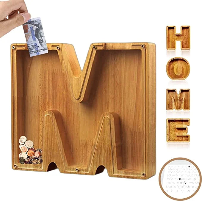 Wooden Alphabet Piggy Bank, personalized with 'B', sitting on a child's desk next to art supplies