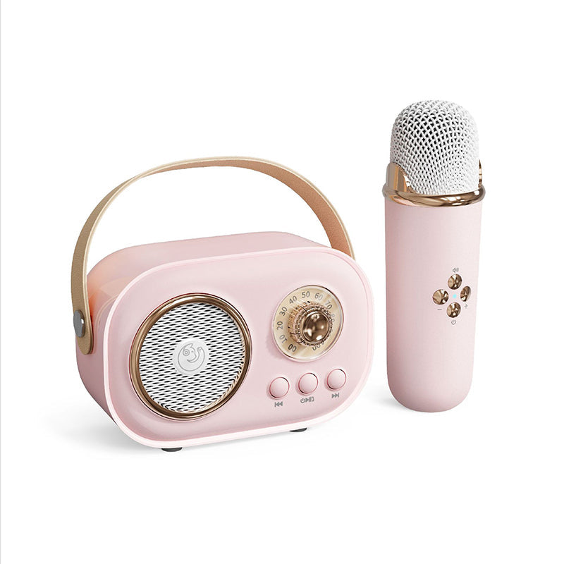 Group of children enjoying a party with a portable karaoke speaker and two wireless microphones.